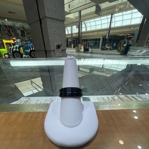 8MM Black Tungsten Men’s band with blue line in center. Size 9. Not sizable.